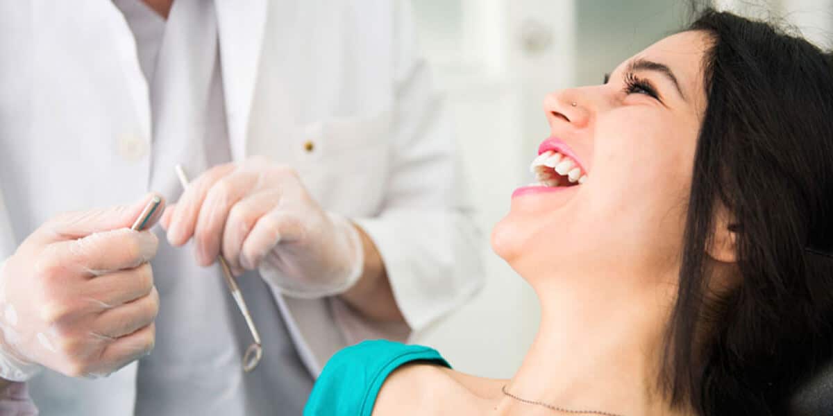 woman laughing in dentist chair